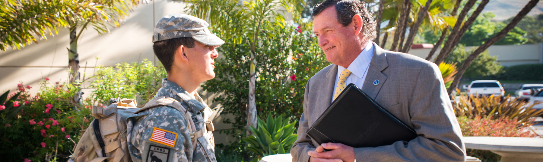 Uniformed troop speaking with CSU Chancellor Timothy White