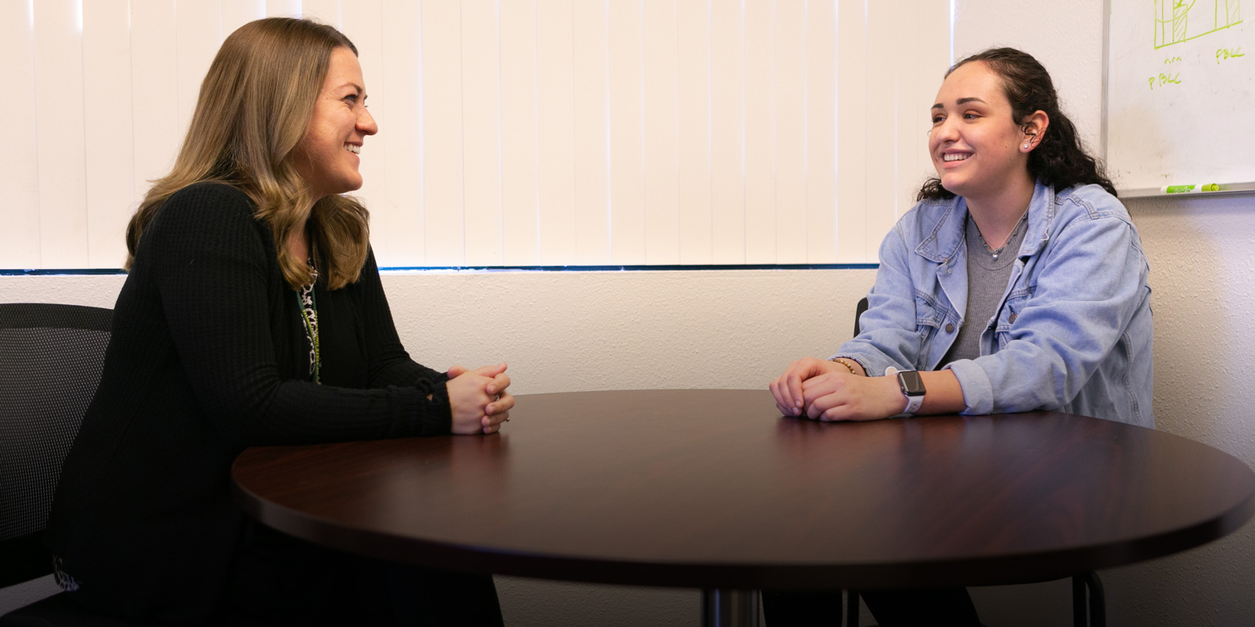 Maria speaks at a table with Katlin Overeem, director of Klamath Connection.
