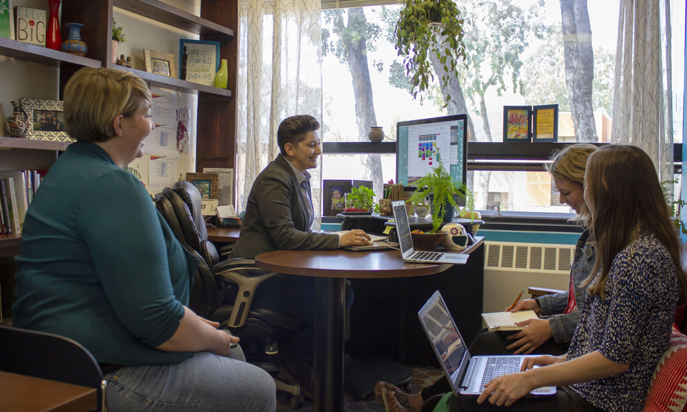 Dr. Jay Bettergarcia and others sitting in an office
