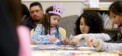 young student with teacher making art