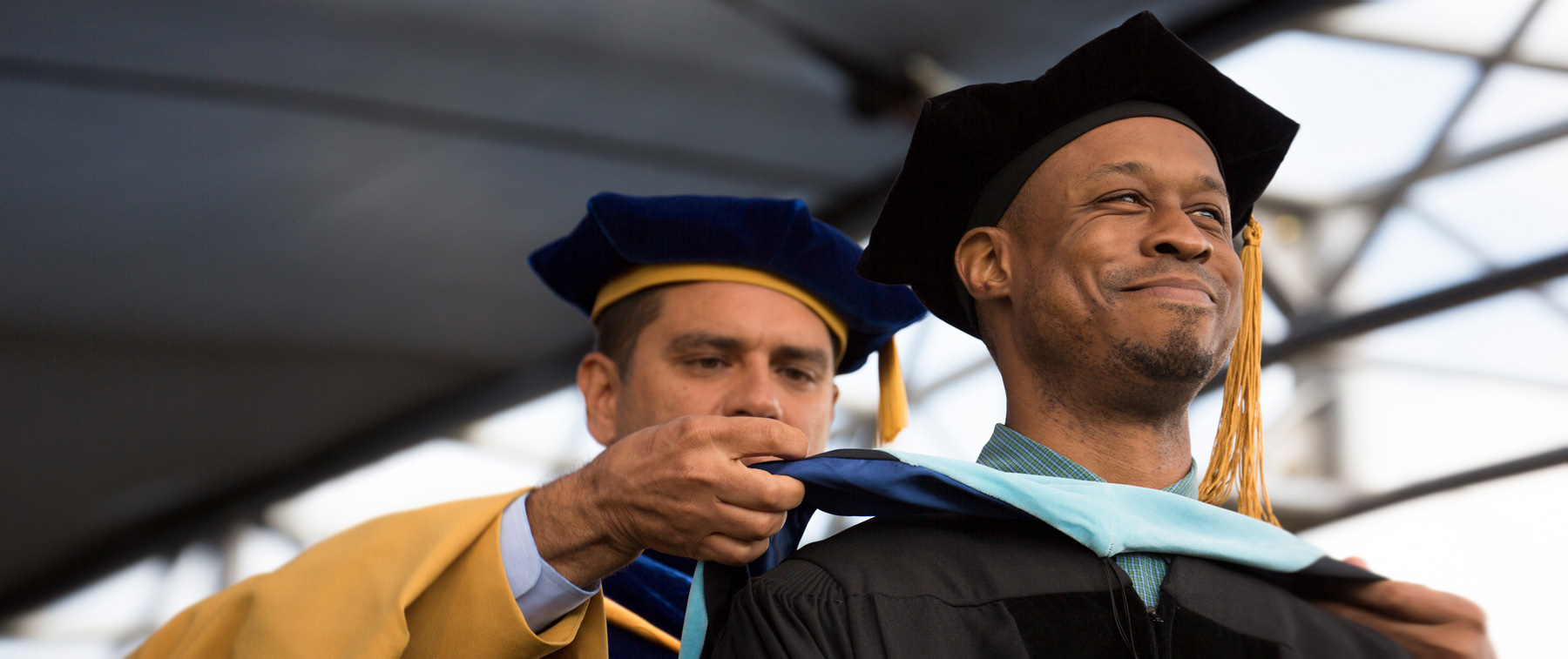 Smiling man receiving a Doctor of Education