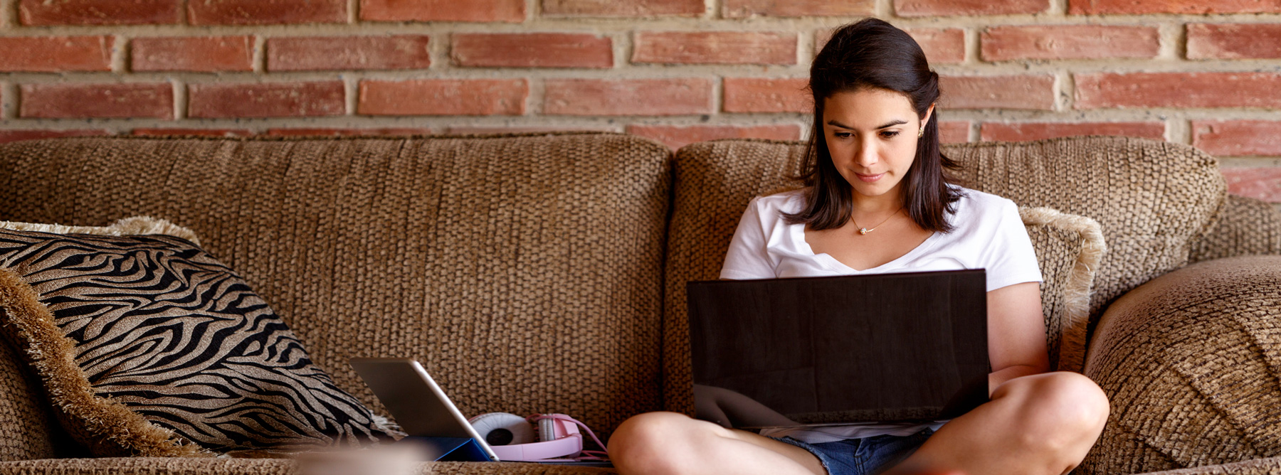 student using her laptop on the couch